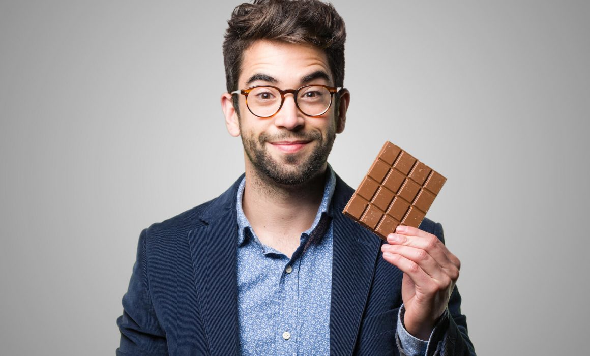 Homme tenant une barre de chocolat